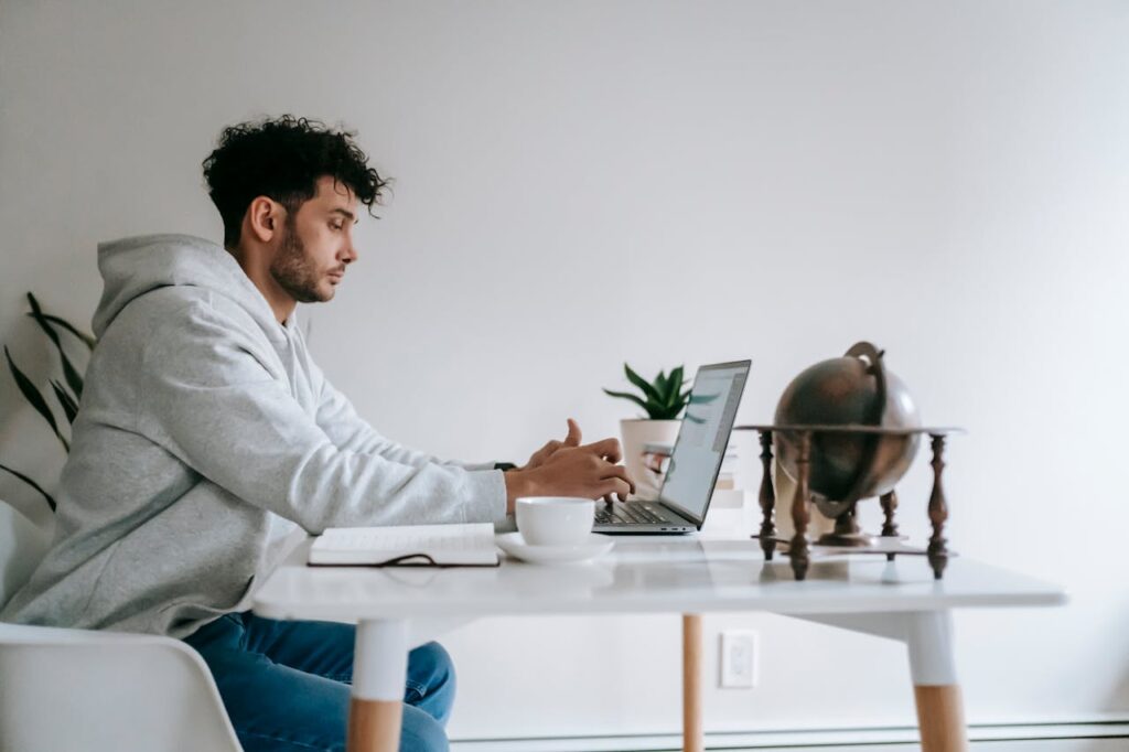 Man working on laptop learning how to build a sucecssful digital business online