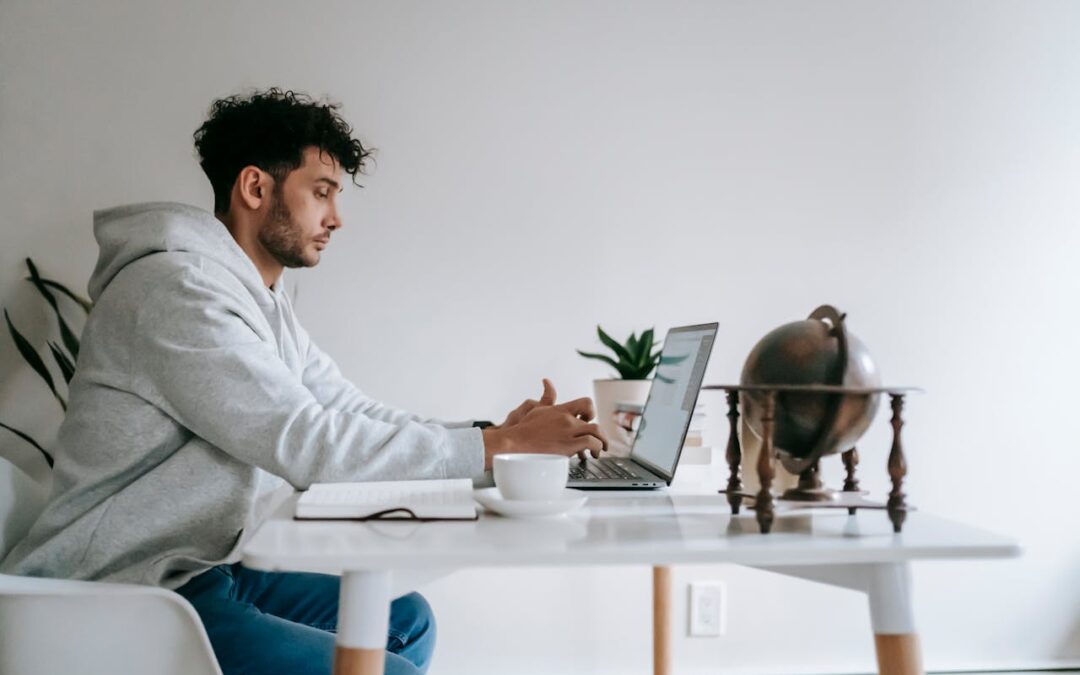 Man working on laptop learning how to build a sucecssful digital business online
