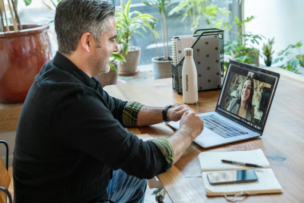 Man doing an interview for a job on a laptop after practicing using AI video interviews